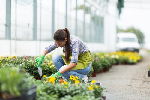 Gardener in Leamouth using safe working practices in a garden
