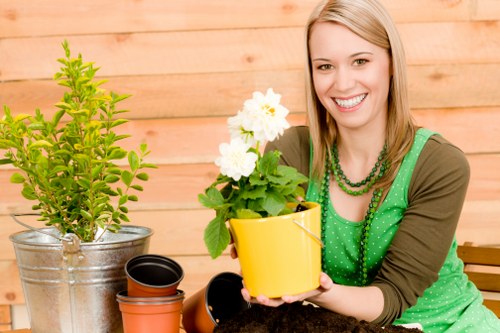 Professional gardeners in Leamouth maintaining a landscaped outdoor space